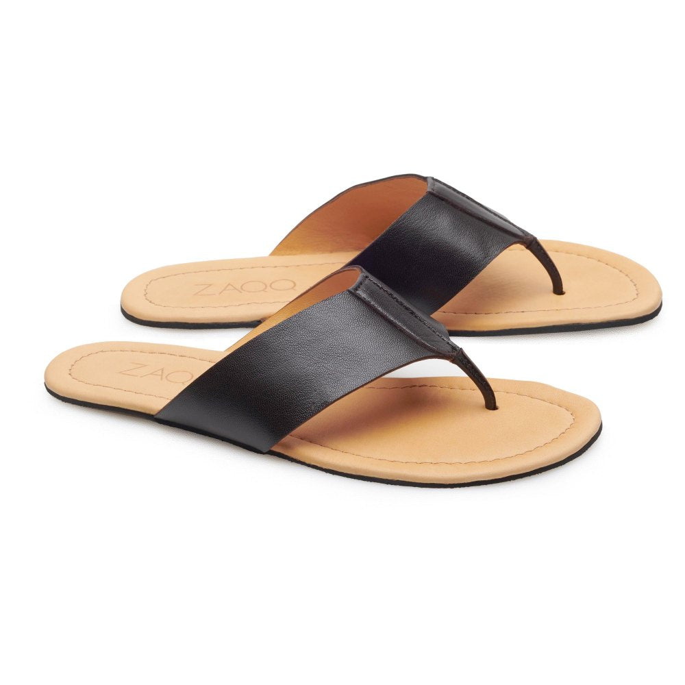 Die QOSS Dark Brown Sandalen von ZAQQ sind aus weichem Nappaleder gefertigt und verfügen über ein schlichtes Zehentrenner-Design mit hellbraunen Sohlen, die die minimalistische Eleganz einer klassischen Barfuß-Sandale verkörpern.