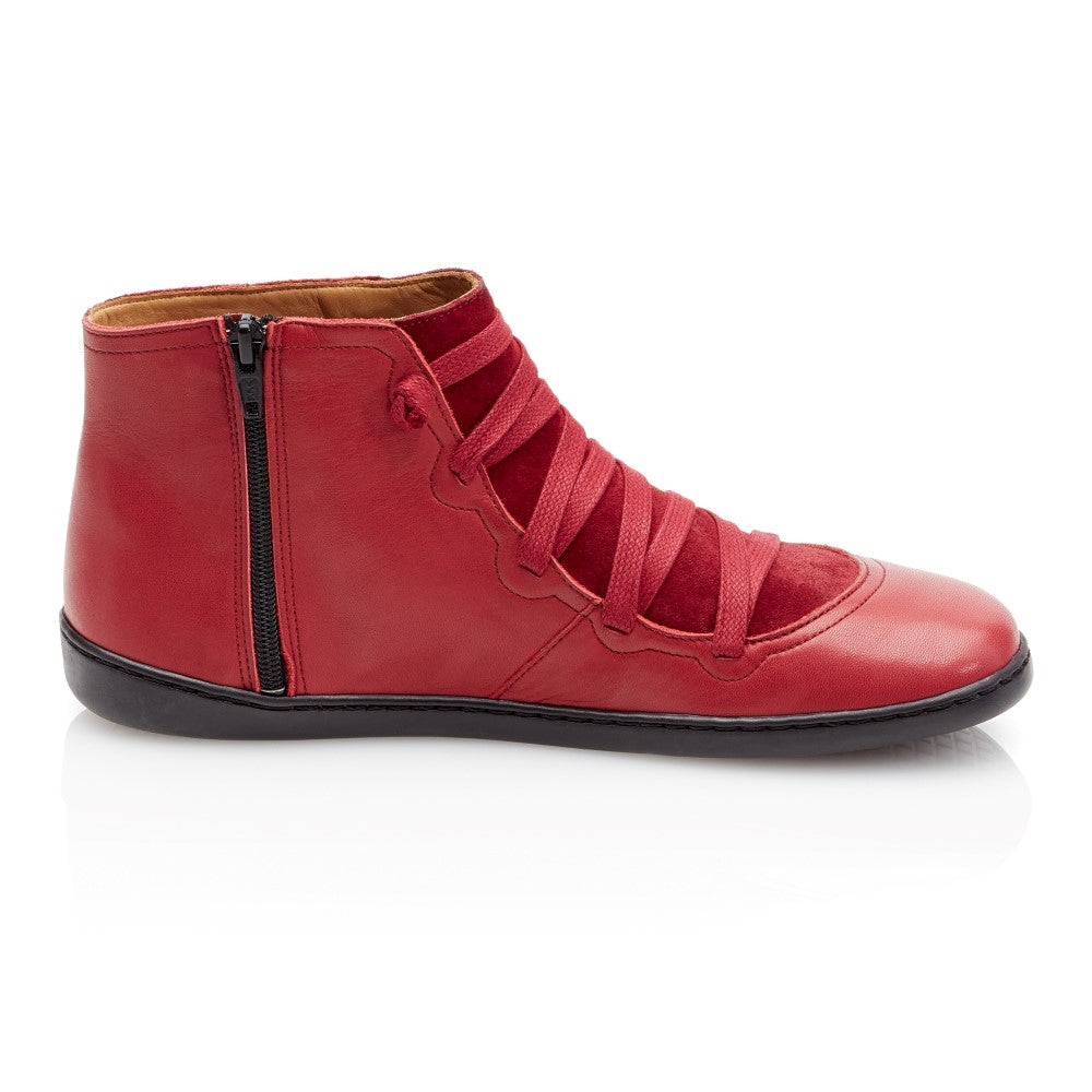 Der Quechee Velvet Sneaker von ZAQQ ist ein roter High-Top aus Leder mit schwarzer Sohle, breiten roten Schnürsenkeln und einem praktischen seitlichen Reißverschluss. Die Innenseite ist hellbraun lackiert und verleiht diesem unverwechselbaren Reißverschluss-Sneaker Komfort und Stil.